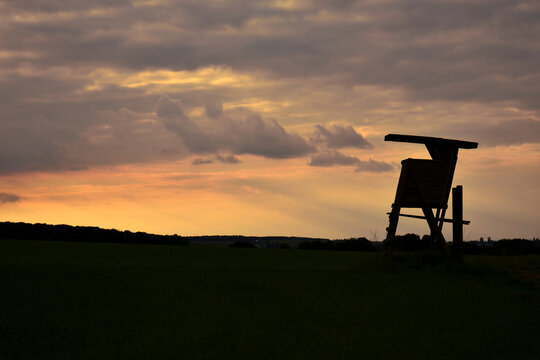 Silhouette of a deer stand for hunting in the sunset