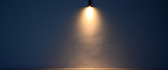 Glowing modern wall led lamp with warm light on white wall. Free space.