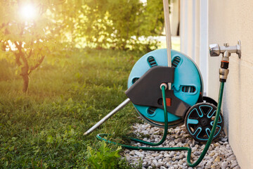 Hose with Faucet Outdoor for Watering. Lawn Sprinkler attached to Mobile Garden Hose Reel and Brass...