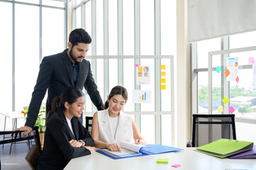 Business people group read some documents, making plans together in the office. Professional businesswomen and businessmen working with paper documents on the meeting table