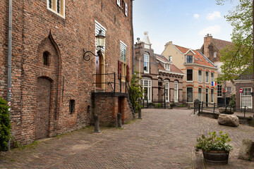 Fototapeta na wymiar Narrow street with Dutch flags in the old medieval center of the Dutch city of Amersfoort.