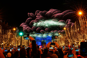 Paris, France - January 1st, 2023 : New Year's fireworks over the Arc de Triomphe (triumphal arch)...