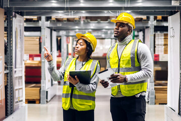 Portrait two african american engineer team shipping order detail on tablet check goods and supplies on shelves with goods inventory in factory warehouse.logistic industry and business export - obrazy, fototapety, plakaty