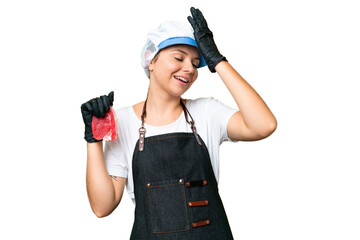 Butcher woman wearing an apron and serving fresh cut meat over isolated chroma key background has realized something and intending the solution