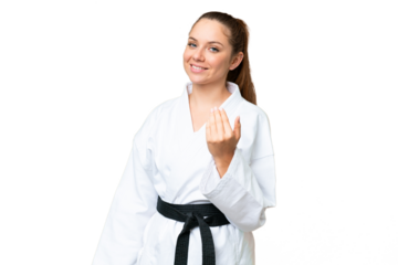 Young blonde woman doing karate over isolated chroma key background inviting to come with hand. Happy that you came