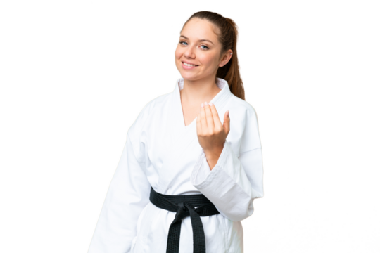 Young blonde woman doing karate over isolated chroma key background inviting to come with hand. Happy that you came
