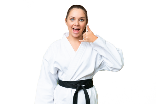 Young blonde woman doing karate over isolated chroma key background making phone gesture. Call me back sign