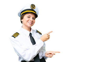 Airplane pilot woman over isolated chroma key background pointing finger to the side and presenting...