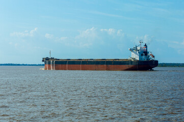 Cargo ships travelling along the Amazonas river in Brazil along the route between manaus and Belem
