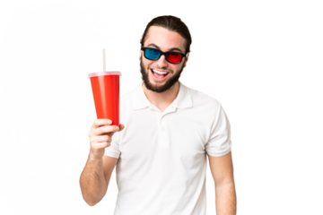 Young handsome man holding soda while watching a 3D movie over isolated chroma key background with surprise and shocked facial expression