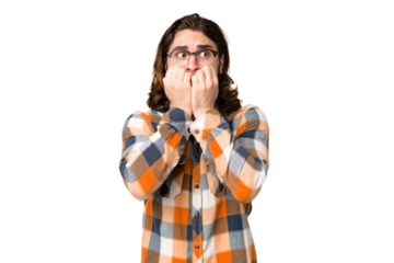 Young handsome man over isolated chroma key background nervous and scared putting hands to mouth