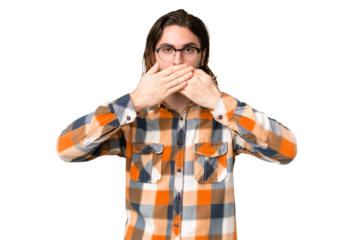 Young handsome man over isolated chroma key background covering mouth with hands
