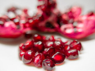 cut pomegranate fruit with berries on a white background