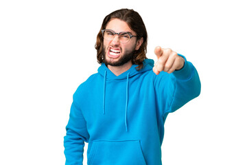 Young handsome man over isolated chroma key background frustrated and pointing to the front