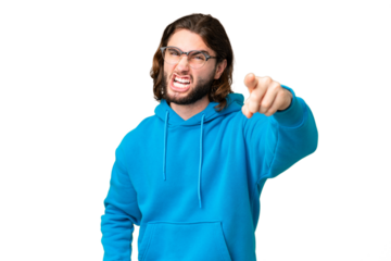 Young handsome man over isolated chroma key background frustrated and pointing to the front