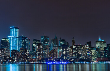 Fototapeta na wymiar Hudson River and Night Cityscape of New York. Manhattan. NYC, USA. Reflection on Water
