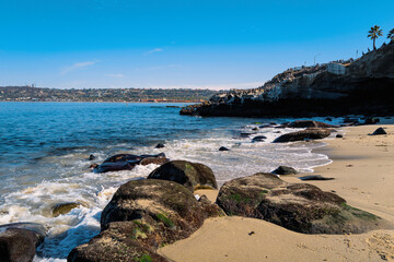 La Jolla Cove Beach Seascape, Rocky beachscape with white waves rolling in on the sand in La Jolla, San Diego, Southern California, USA
