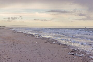 Picture of transport ship on stormy sea photographed from a beach