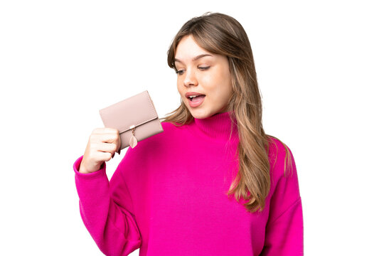 Young girl holding a wallet over isolated chroma key background with happy expression