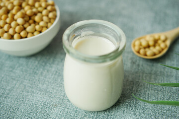 slow motion of soy milk pouring in a glass jar 