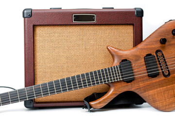 An electric guitar and a vintage looking combo amp shot against a white background.