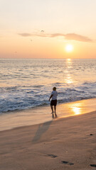 Young man walking on the shore of the beach in costas de oaxaca at sunset