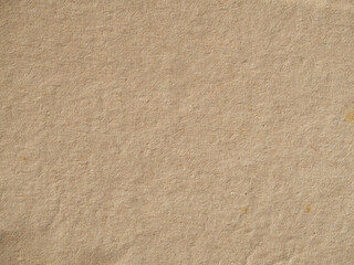 Old vintage paper background texture. Close-up of brown cardboard paper with a rough fibrous texture of the background surface