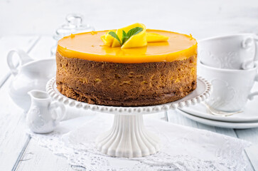 Traditional German cheesecake with mango served as close-up on a cake plate
