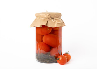 Pickled red cherry tomatoes in a glass jar isolated on white background. Food preservation for autumn or winter. Home storage. Canning, fermentation concept. Place for text. Copy space.
