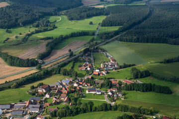 View from a motor glider over the picturesque landscape of Franconian Switzerland/Germany with small villages