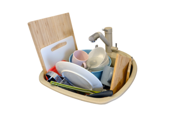 Sink with dirty dishes in the kitchen, isolated on a white background. Plates, cups, cutlery and cutting boards lie in the sink