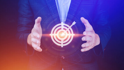 Targeting concept with businessman hand holding digital image of dartboard,Businessman holding virtual dartboard and arrow with copy space for setup business objective target concept.