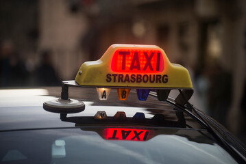 Strasbourg - France - 31 December 2022 - Closeup of french taxi sign on the roof of car in the...