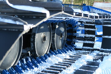 Obraz na płótnie Canvas machine wheels in whte snow in ski area skalka above village of kremnica in slovakia with sights and locations with sunshine in winter