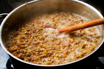 Preparing lentil in cooking pot
