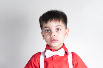 Cute boy in classic clothes on white background