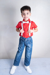 Cute boy in classic clothes on white background