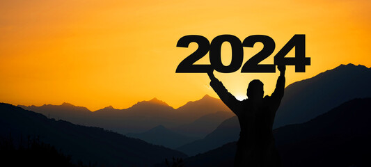 Landscape background banner panorama 2024 - Breathtaking view with black silhouette of mountains...