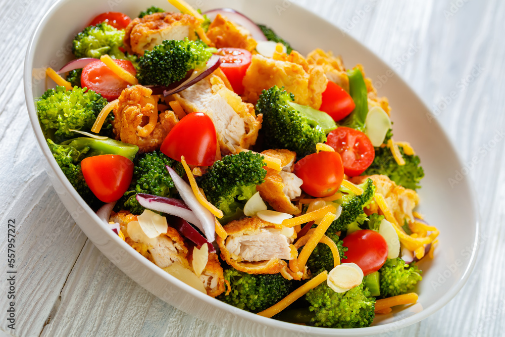 Poster fried chicken tenders broccoli salad in bowl