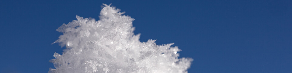 Fototapeta premium Banner 4:1 with snowflakes and ice floes against a dark blue sky
