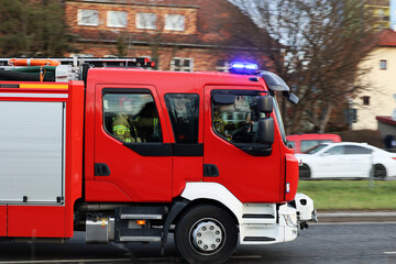 Wóz straży pożarnej jedzie alarmowo do akcji ratowniczej i gaśniczej.