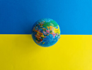 World globe Ukrainian flag background blue and yellow