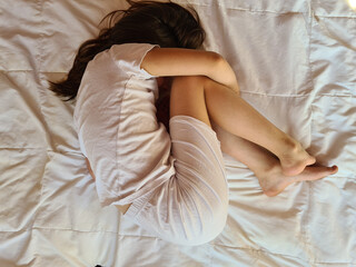 Little girl in bed has stomach ache and diarrhea