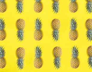 Pineapple on the yellow background. Flat lay. Pattern. Top view.