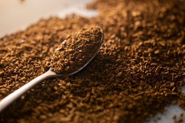 Instant Coffee granules shot in beautiful lighting with a silver teaspoon