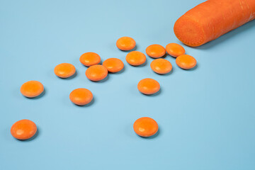 Orange vitamin D pills and a carrot