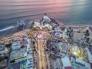 Vista aérea con drone del puerto de Mazatlán al atardecer con muchos colores. 