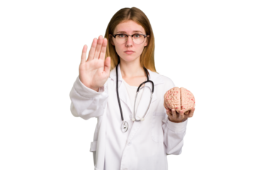 Young doctor caucasian woman holding a brain isolated standing with outstretched hand showing stop sign, preventing you.