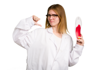 Young caucasian chiropodist woman holding an insoles for shoes isolated feels proud and self confident, example to follow.