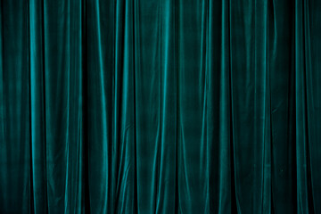 Teal curtain in theatre.